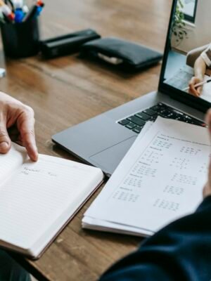 A professional conducting an online class through a video call with a student.